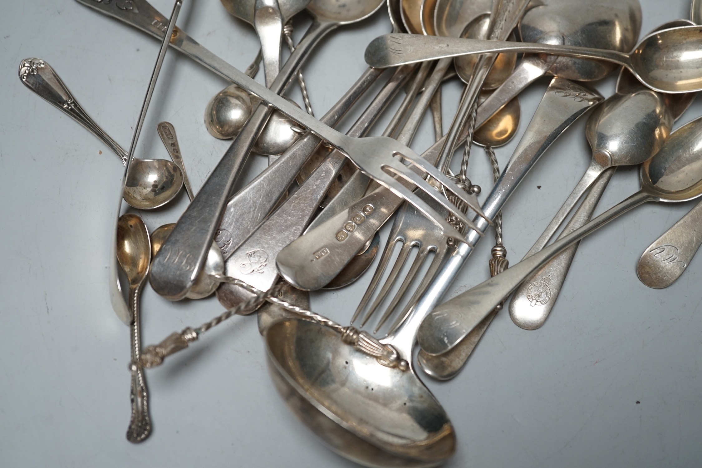 Assorted 19th century and later silver flatware, including dessert spoons, coffee spoons, two ladles, pickle forks, etc. various date and makers, 18.8oz.